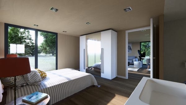 Chambre moderne et lumineuse dans un module en bois avec grande baie vitrée donnant sur un espace vert.