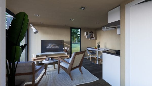Intérieur moderne d'un module en bois avec salon lumineux, coin repas et kitchenette
