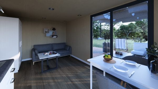 Studio modulaire en bois éco-conçu avec baie vitrée, espace salon-salle à manger lumineux et vue sur jardin