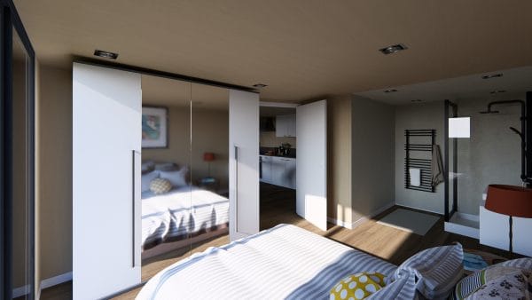 Chambre moderne et lumineuse dans un module en bois avec grande armoire miroir et aperçu de la cuisine intégrée.